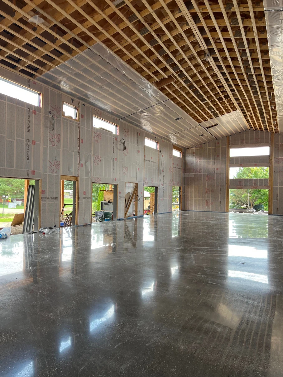Polished concrete floor by Fēnix Finish in a timber hall