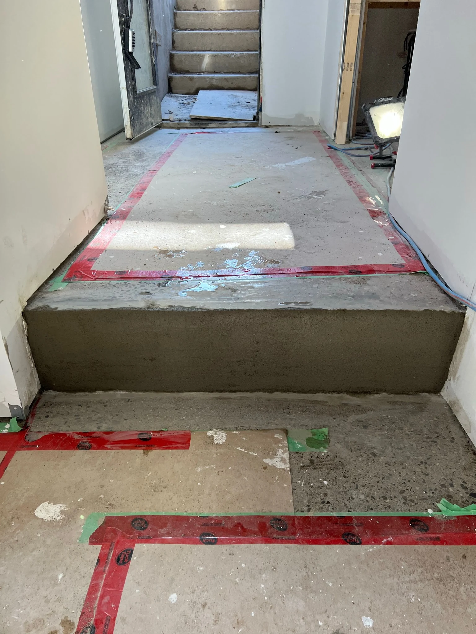 Rebuilt concrete step and patched slab, prepared for new flooring